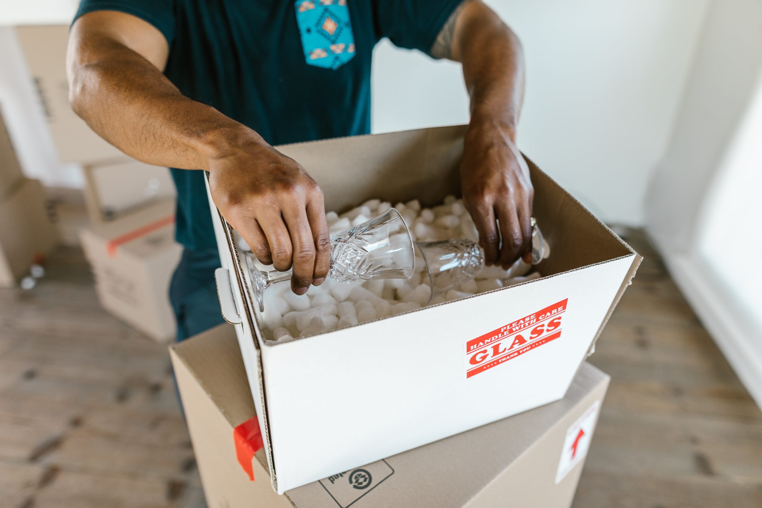Packing fragile glass items in a box.